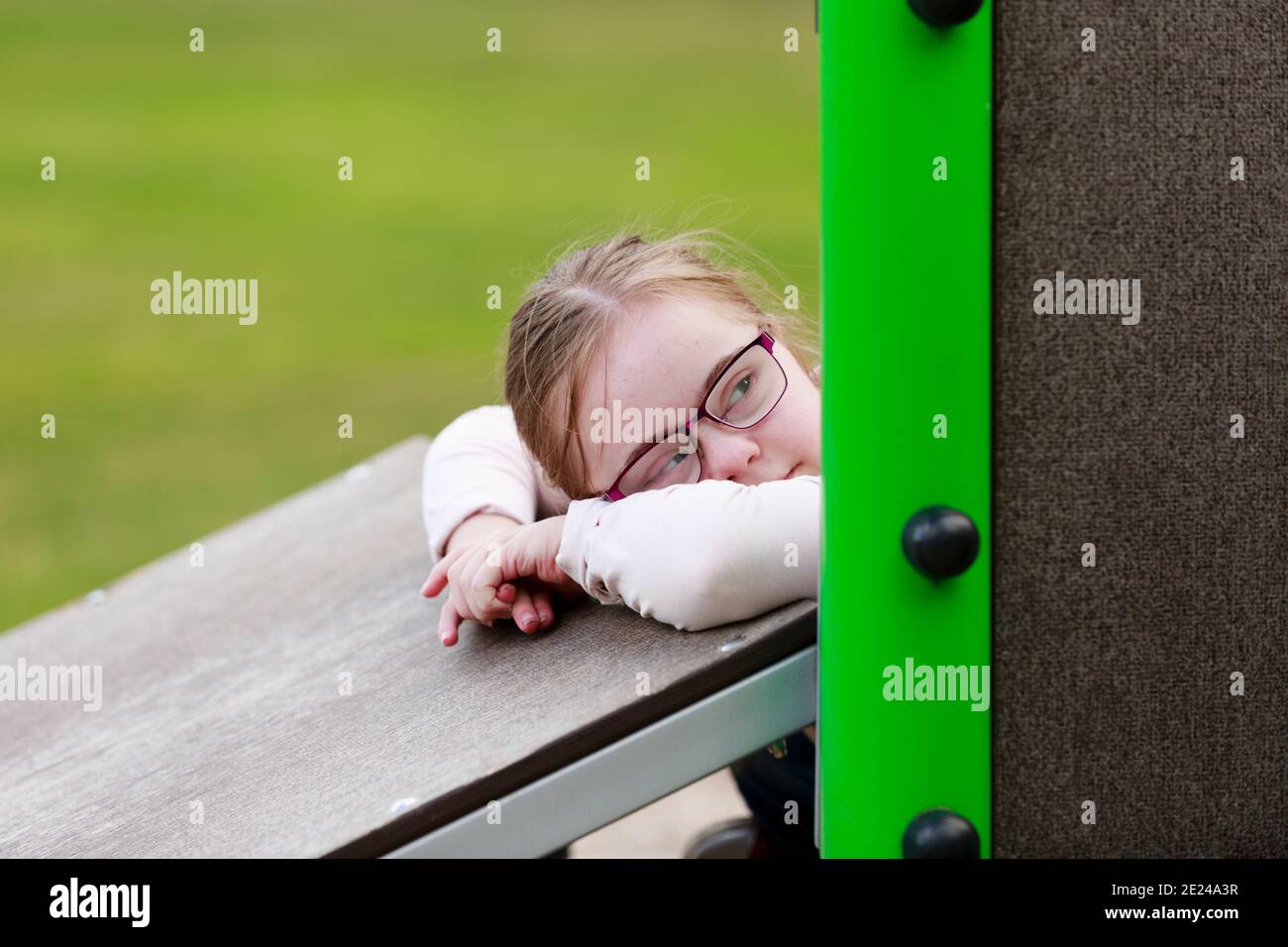 Girl on playground looking away Stock Photo