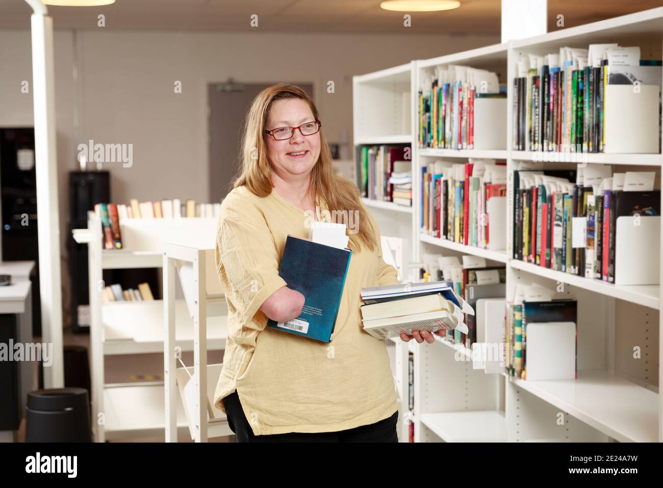 Portrait of librarian holding a book Stock Photo