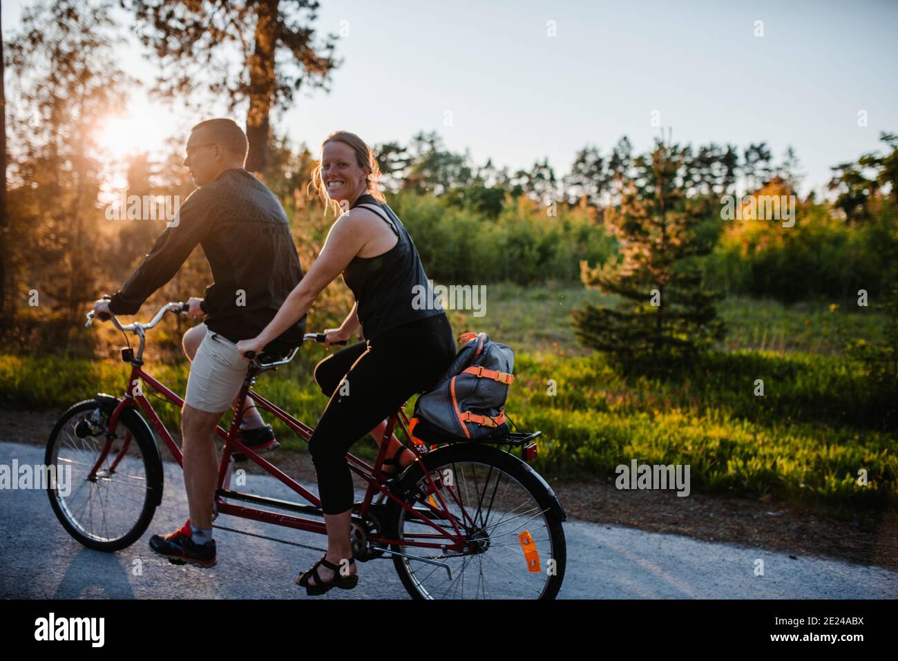Couple riding tandem bike Stock Photo Alamy