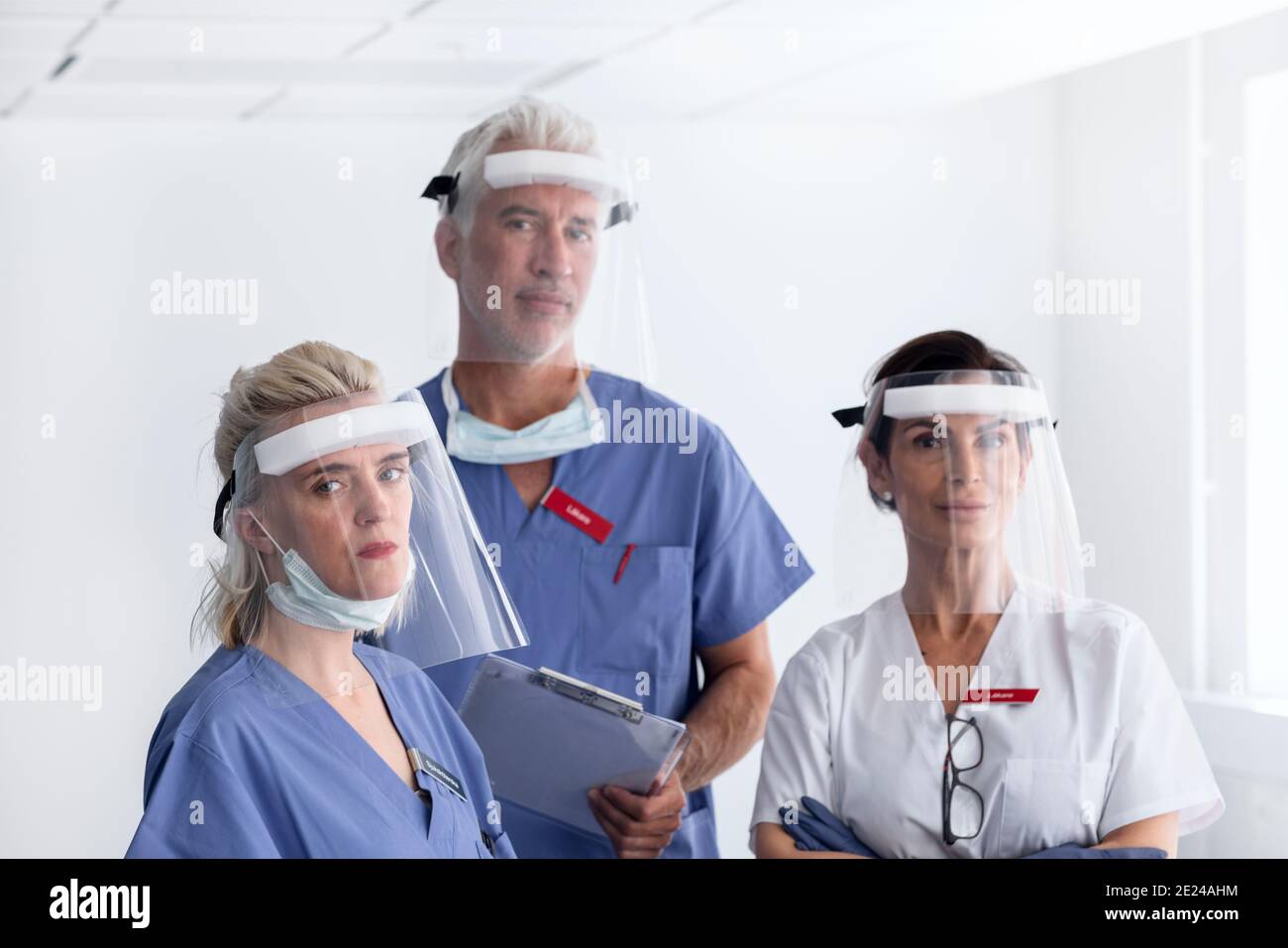 Doctors wearing personal protective equipment in hospital Stock Photo