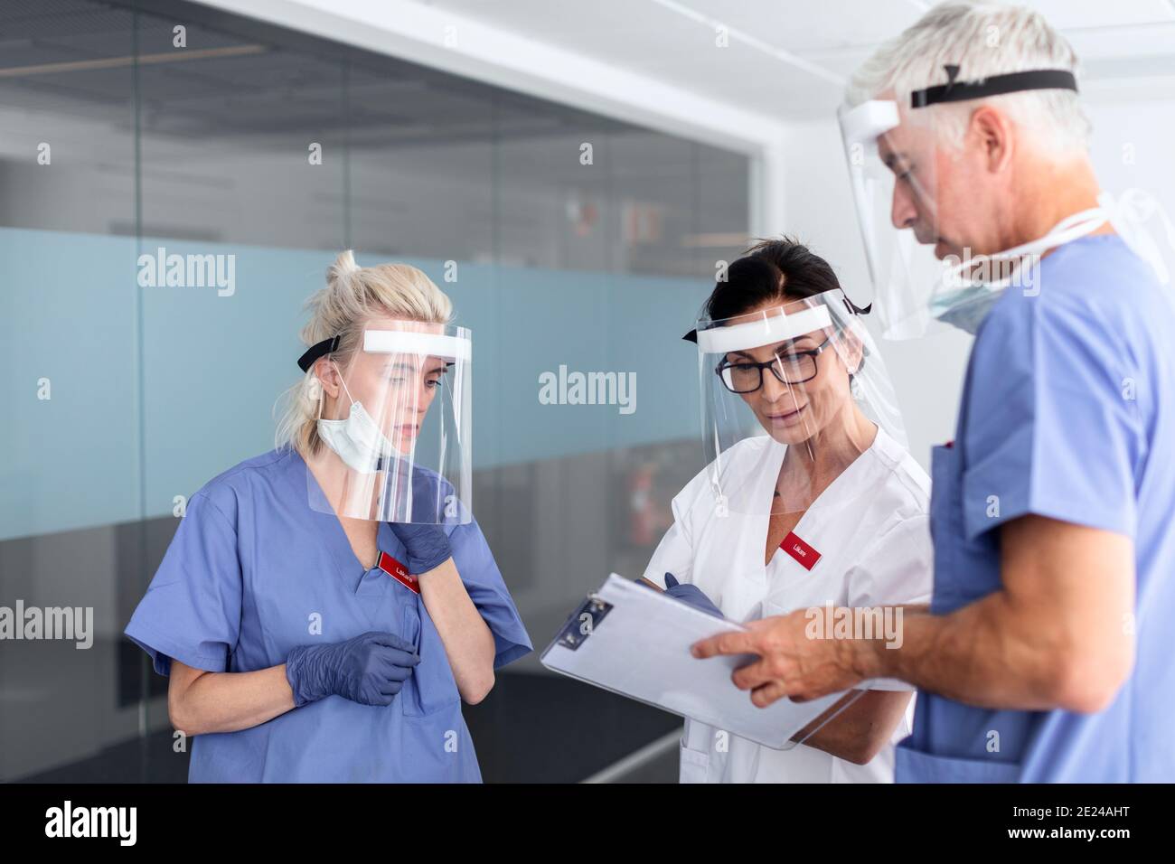 Doctors wearing personal protective equipment in hospital Stock Photo