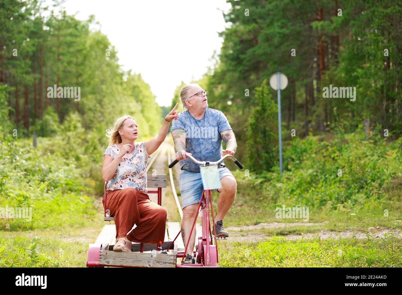 Couple riding handcar Stock Photo