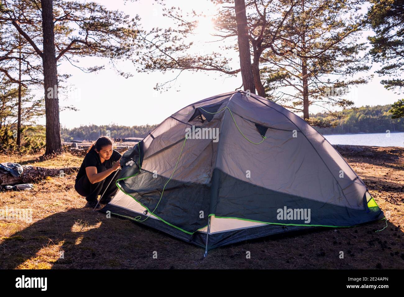 Woman checking tent Stock Photo