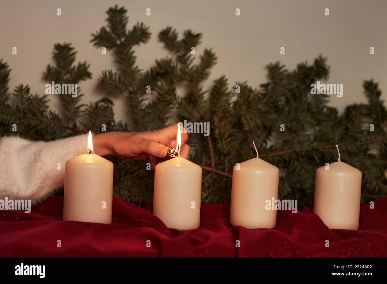 Hand lighting Advent candle Stock Photo Alamy