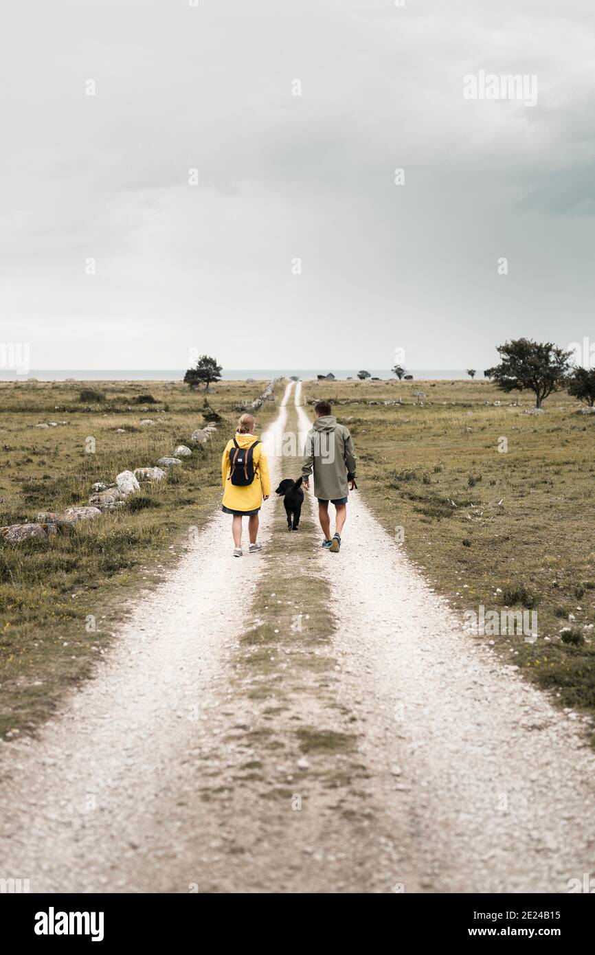 Couple walking with dog Stock Photo
