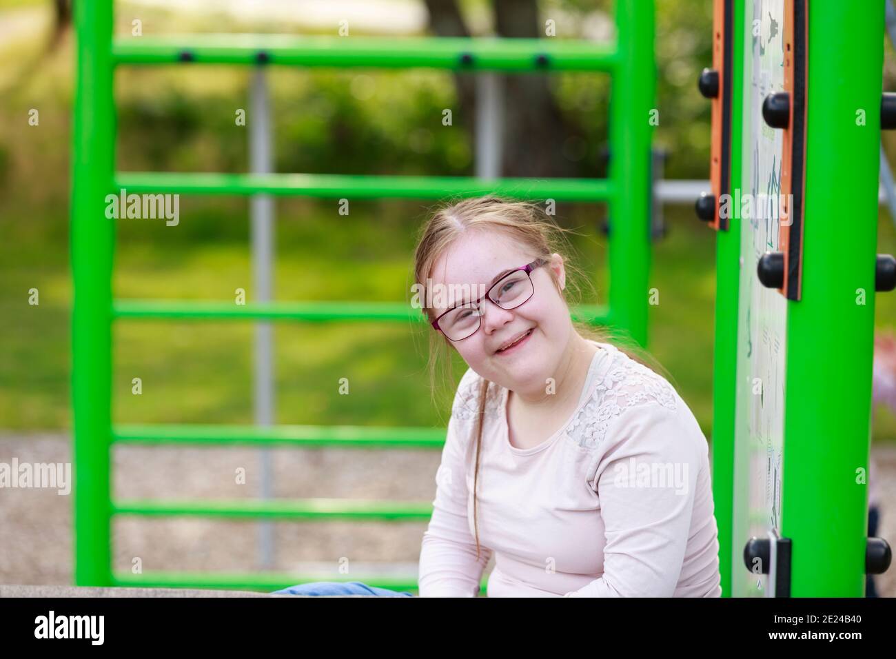 Smiling girl on playground looking at camera Stock Photo