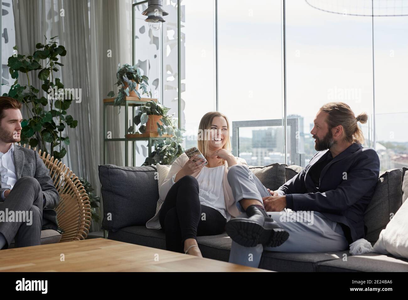 Coworkers talking on sofa Stock Photo