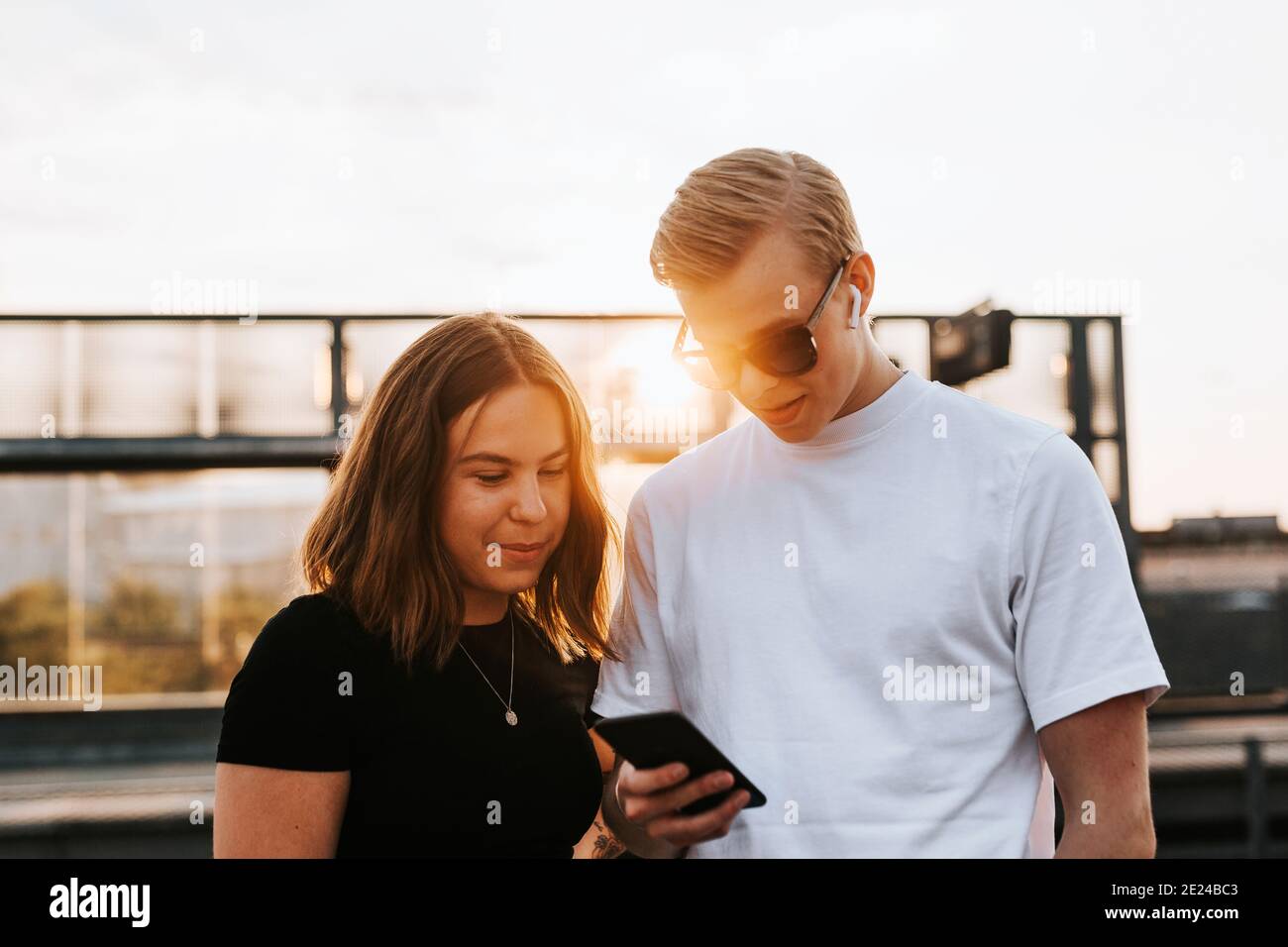 Young friends looking at cell phone Stock Photo