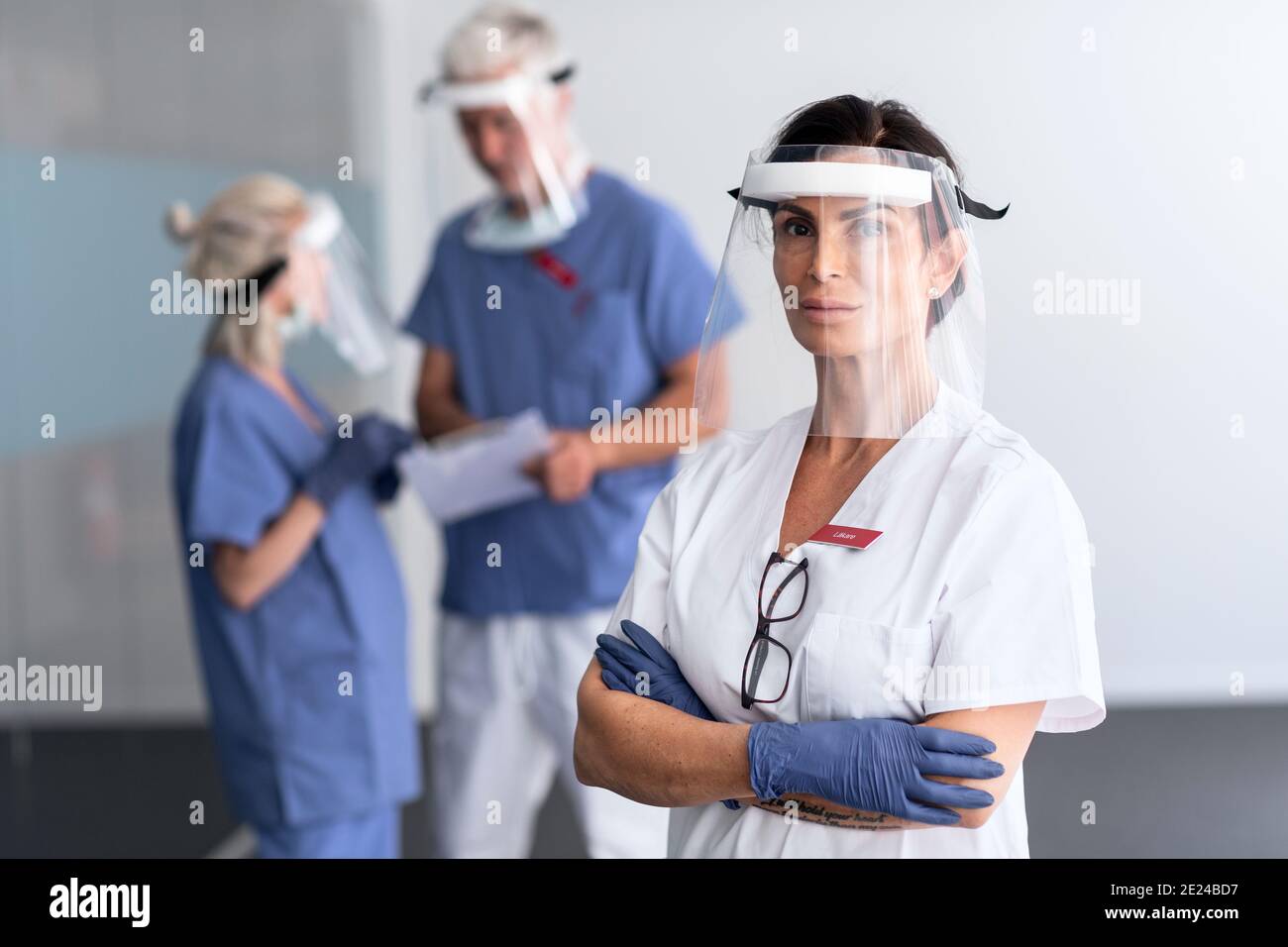 Doctors wearing personal protective equipment in hospital Stock Photo