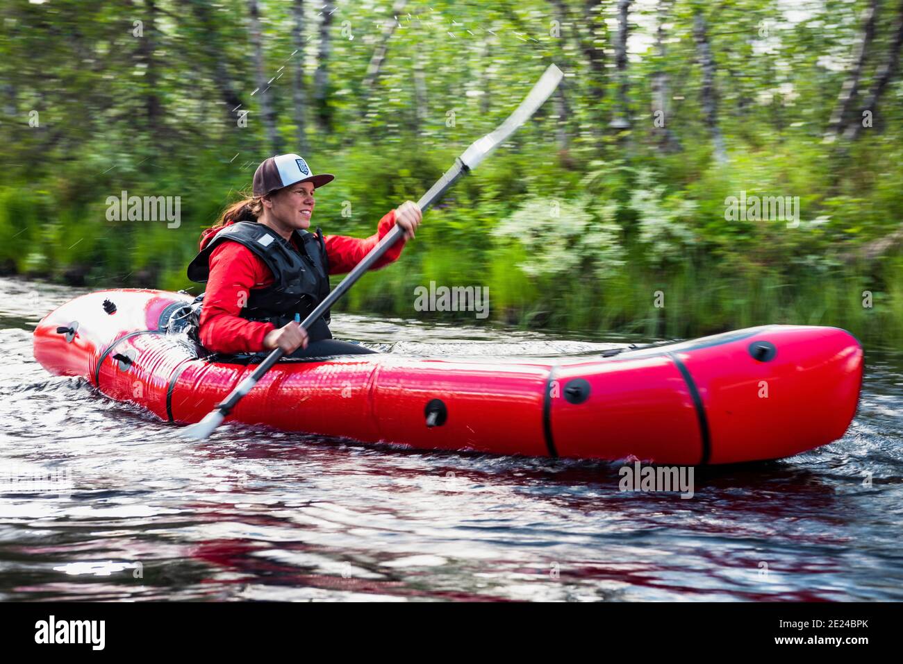 Woman kayaking on river Stock Photo