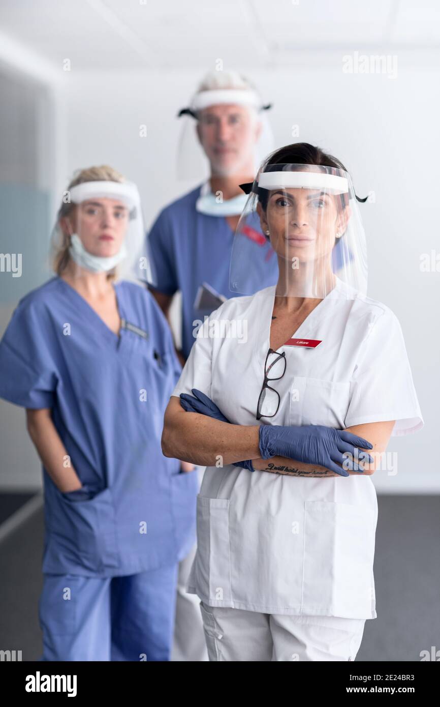 Doctors wearing personal protective equipment in hospital Stock Photo