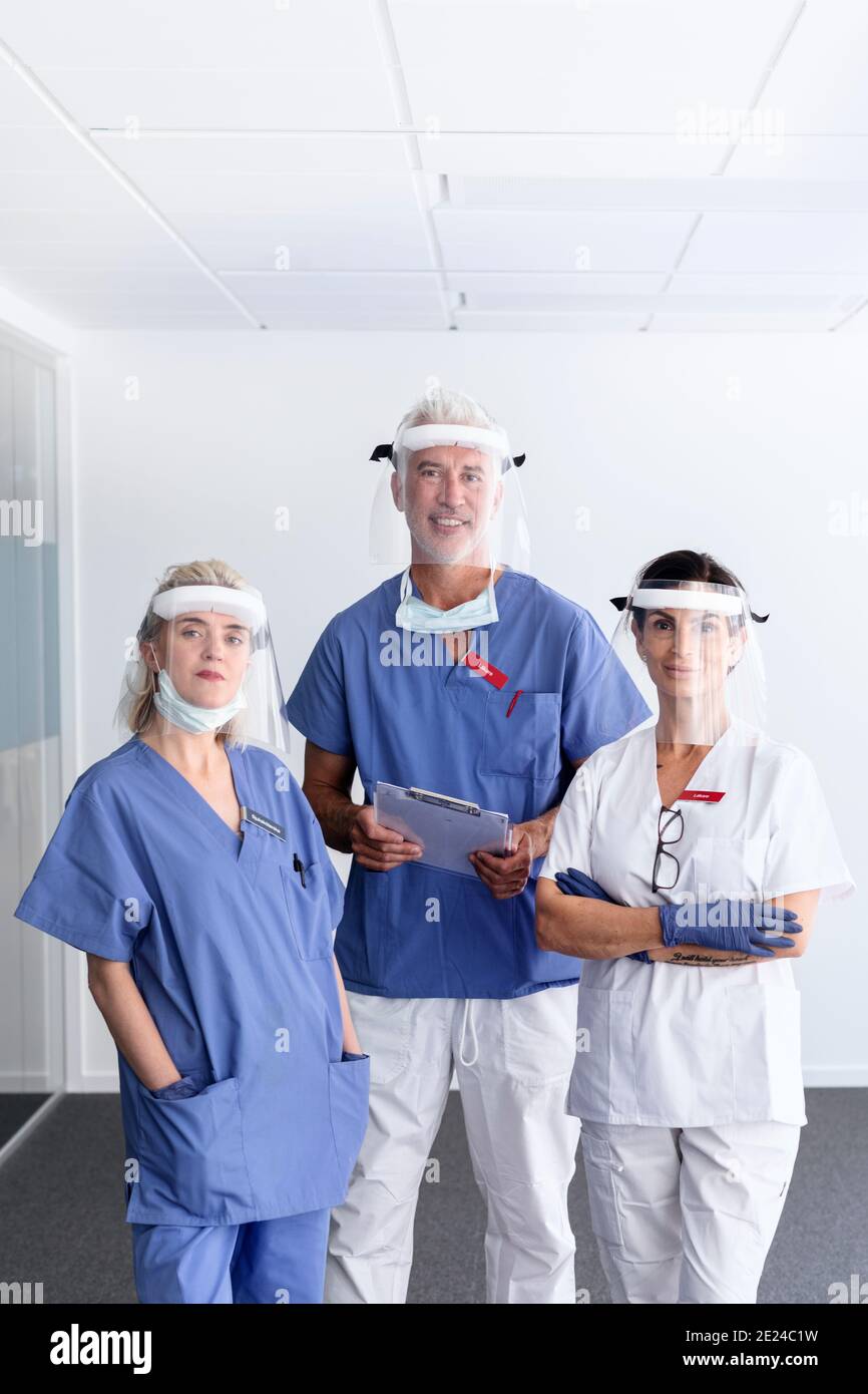 Doctors wearing personal protective equipment in hospital Stock Photo