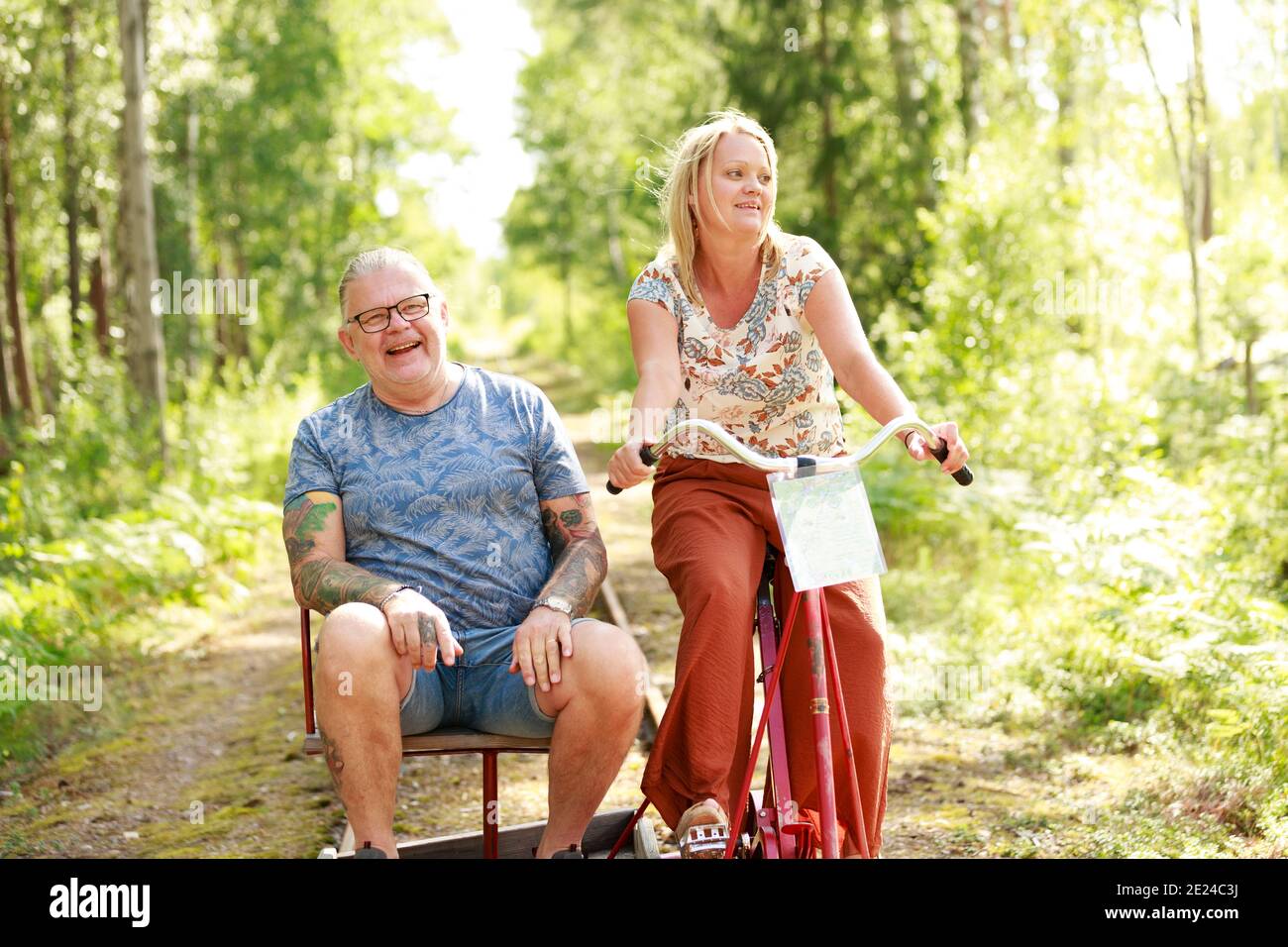 Couple riding handcar Stock Photo