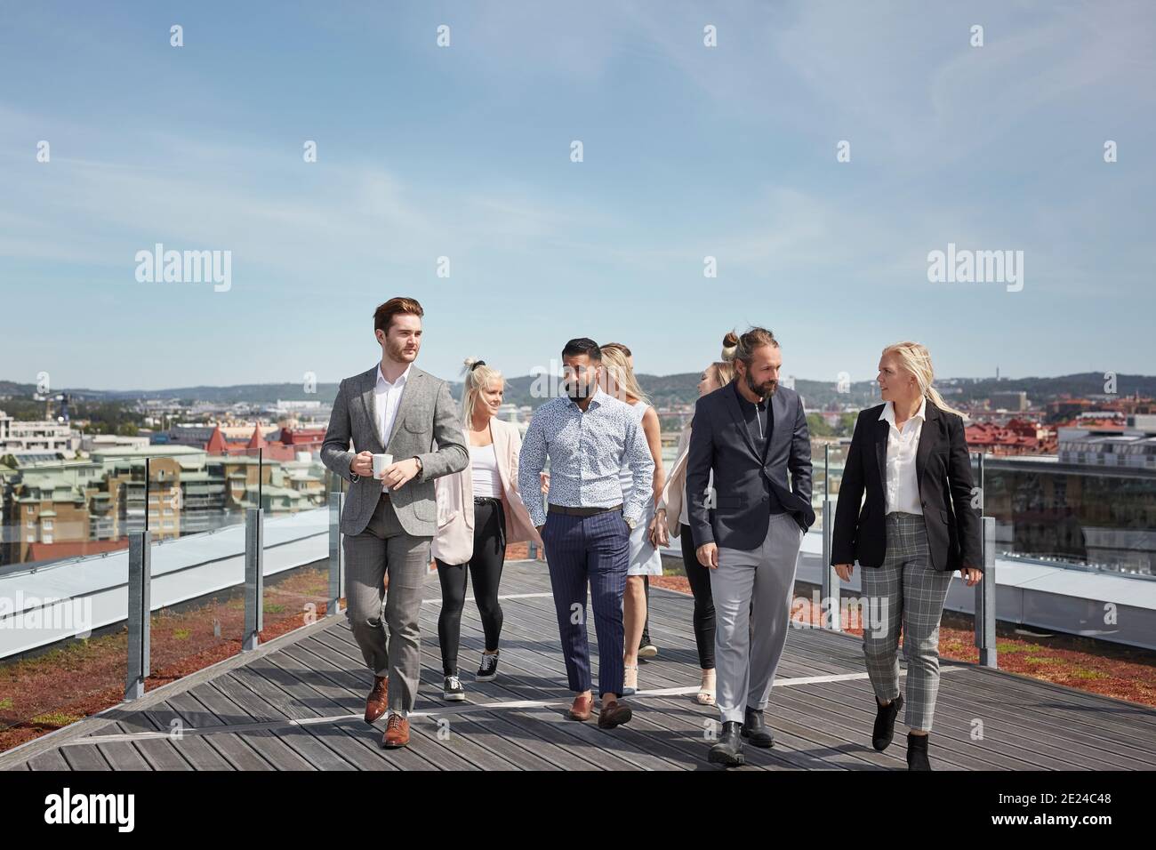 Coworkers walking on terrace Stock Photo