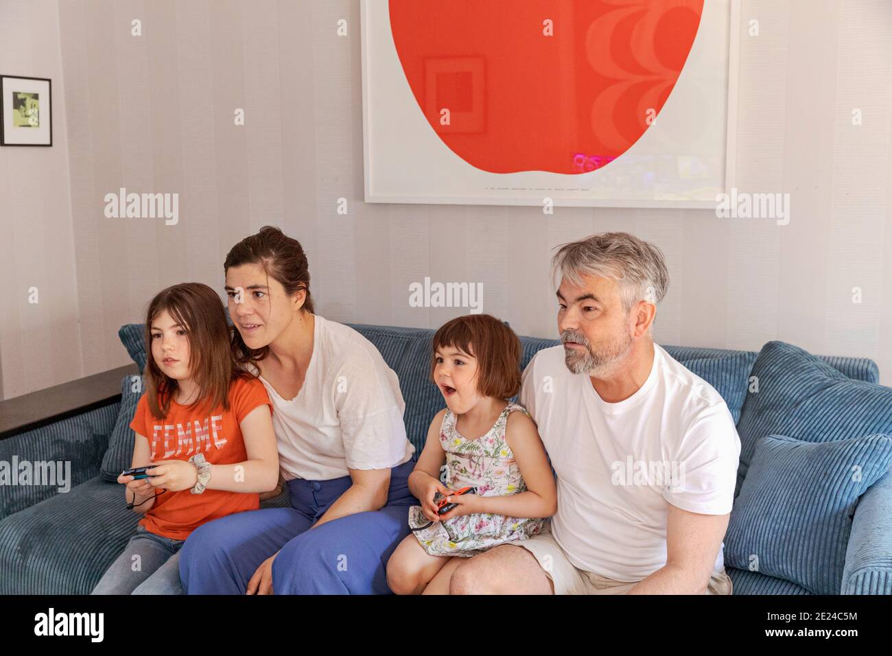 Family watching TV on sofa Stock Photo