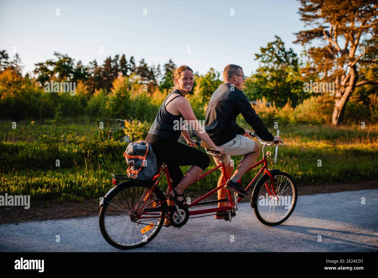 Couple riding tandem bike Stock Photo Alamy