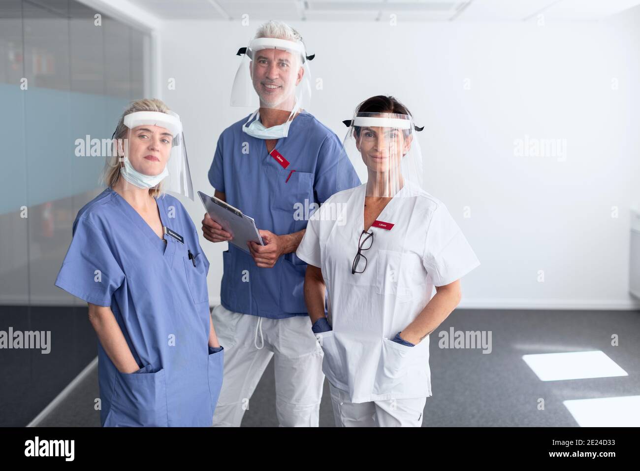 Doctors wearing personal protective equipment in hospital Stock Photo