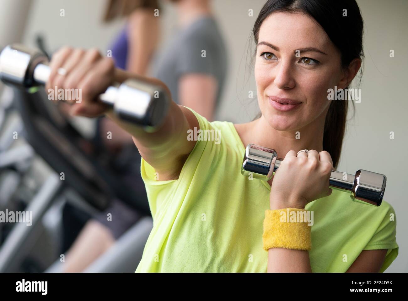 Happy fit fitness girl exercising indoor in fitness center Stock Photo