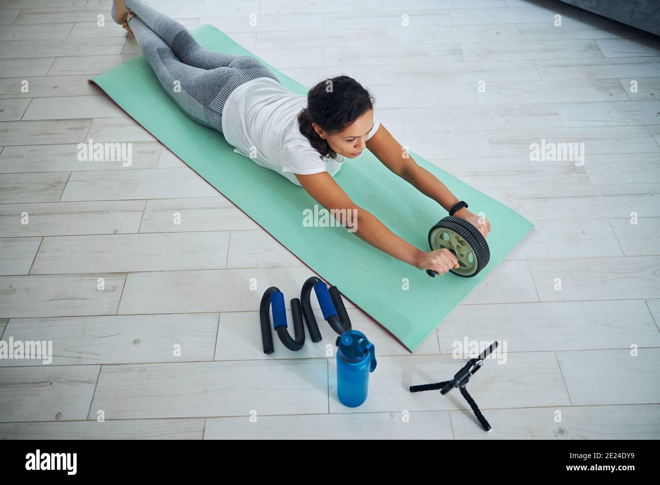 Female fitness vlogger using an abdominal roller Stock Photo Alamy