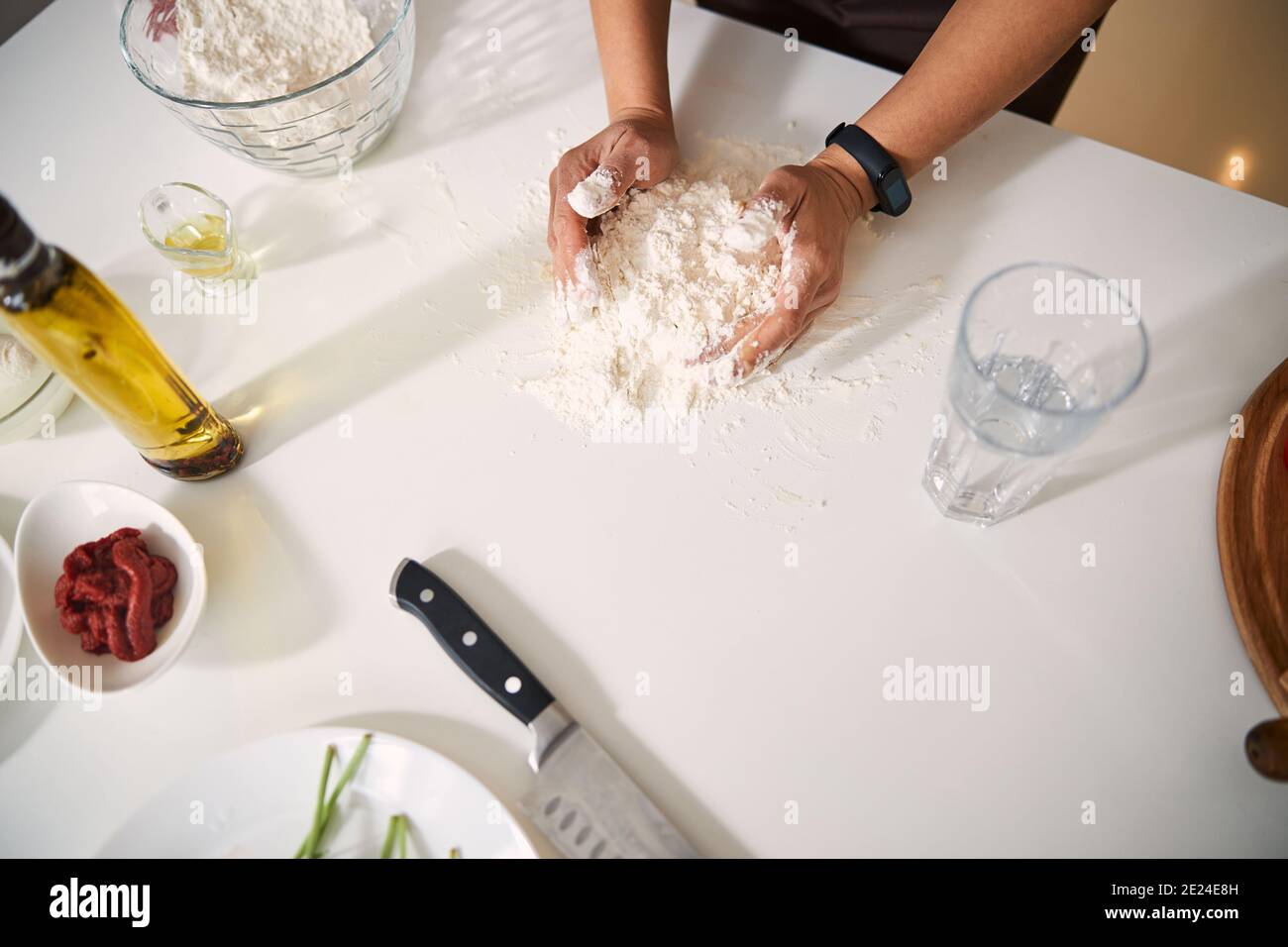 Mixing pile of flour with water while cooking Stock Photo Alamy