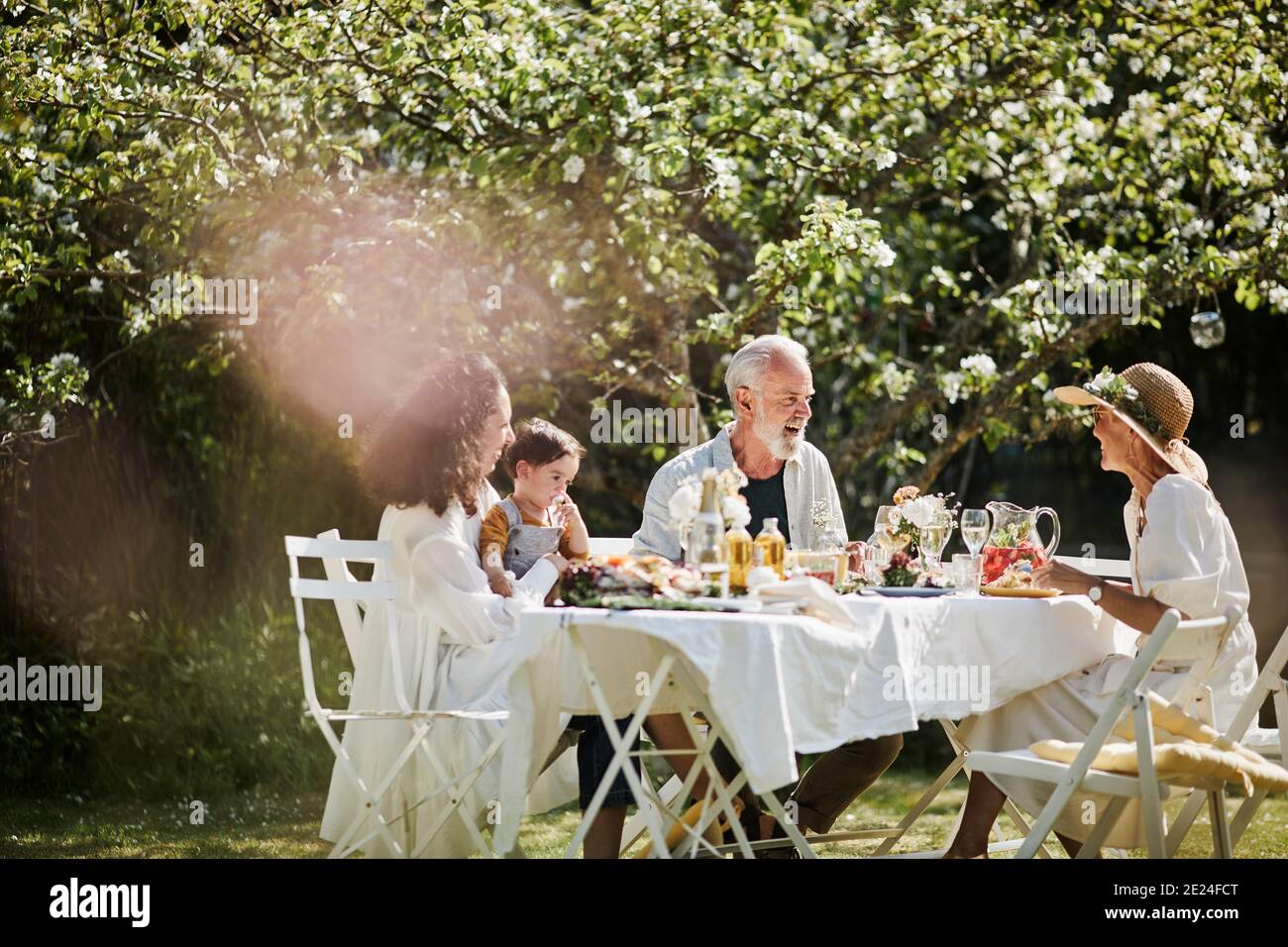 Family having meal in garden Stock Photo