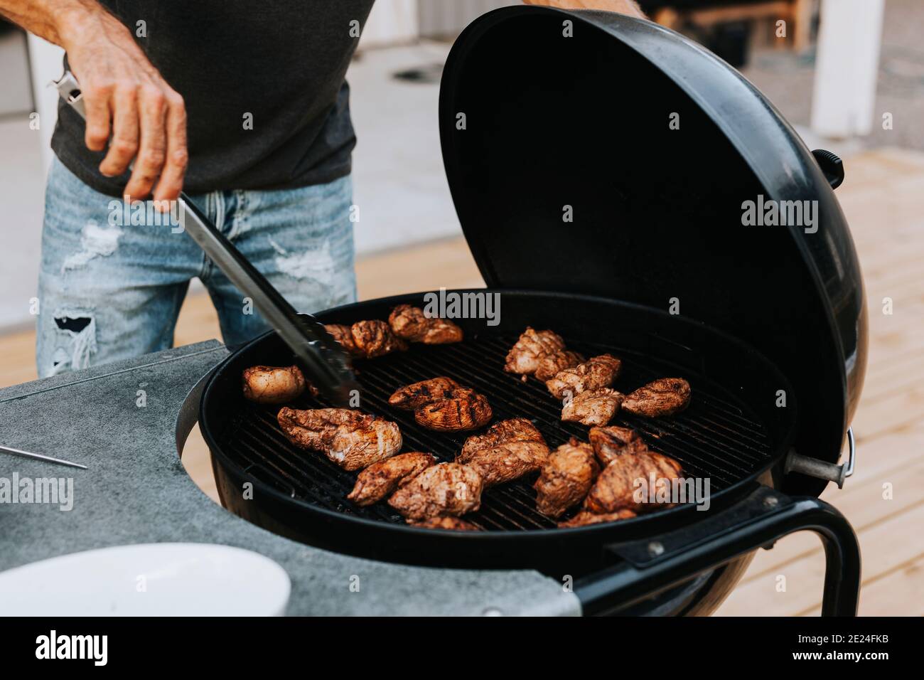 Man preparing meat on barbecue Stock Photo
