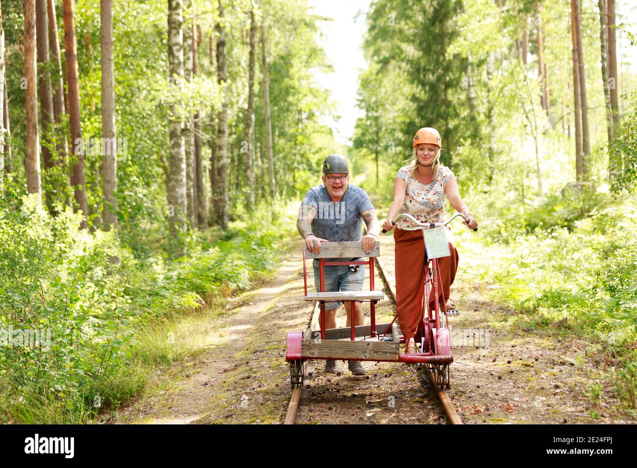 Couple riding handcar Stock Photo