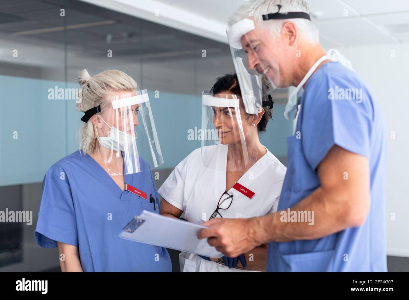 Doctors wearing personal protective equipment in hospital Stock Photo