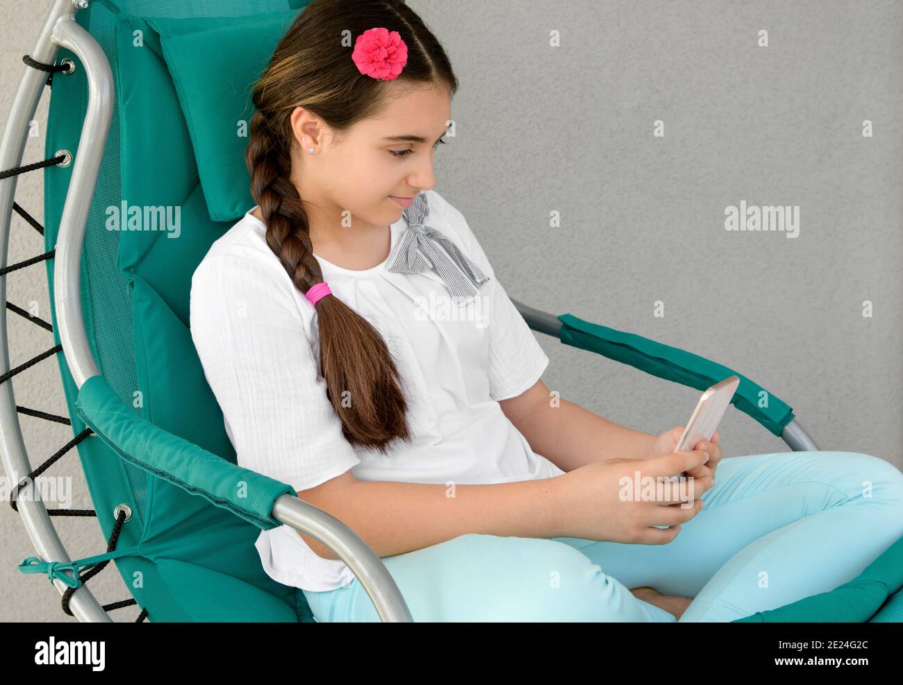 Preteen girl sitting in chair hi-res stock photography and images - Alamy