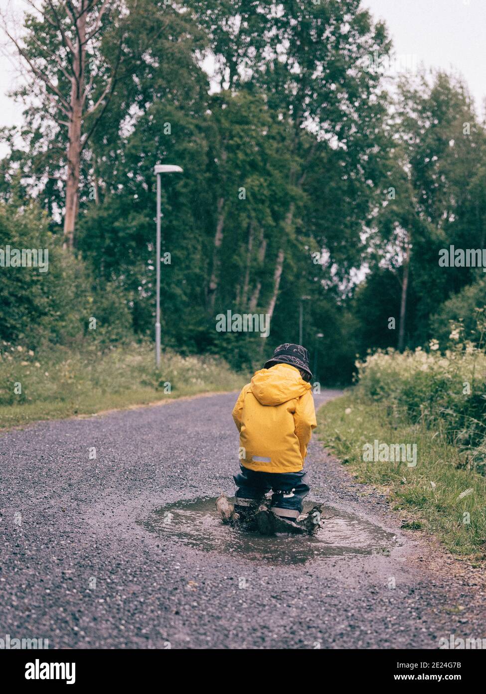 Boy jumping in puddle hi-res stock photography and images - Alamy