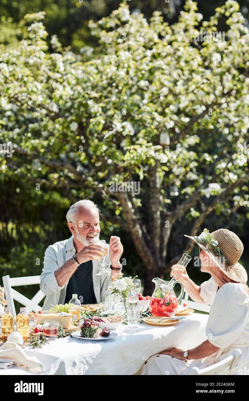 Couple having meal in garden Stock Photo