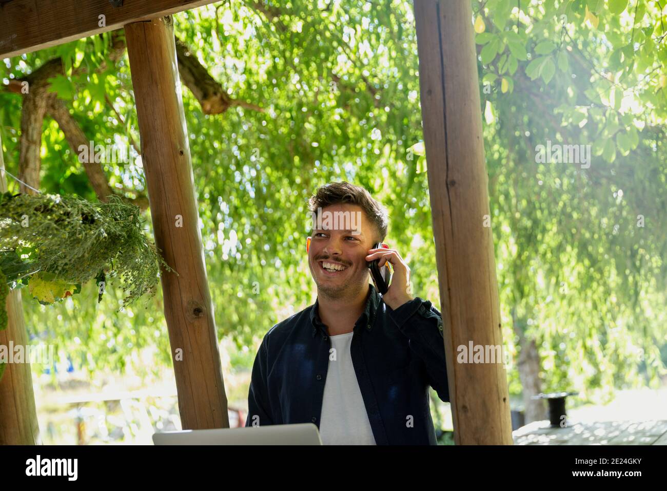 Smiling man talking via cell phone Stock Photo