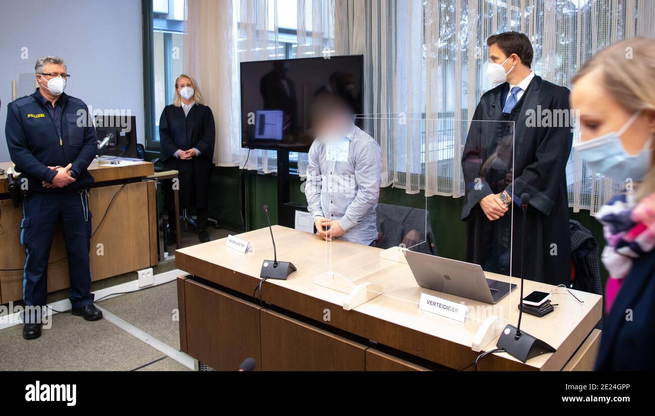 12 January 2021, Bavaria, Munich: The 35-year-old accused of murder (3rd from left) stands in the courtroom with his lawyer Tom Heindl (2nd from right) in the regional court before the start of the trial. The man had raced through the city on the opposite lane shortly before midnight on Nov. 15, 2019, fleeing a police checkpoint, and hit - at more than 120 kilometers per hour, according to the prosecution - two 14- and 16-year-old teenagers who were crossing the street. The 14-year-old died, the 16-year-old was seriously injured. The prosecution accuses him of murder. Photo: Sven Hoppe/dpa - A Stock Photo