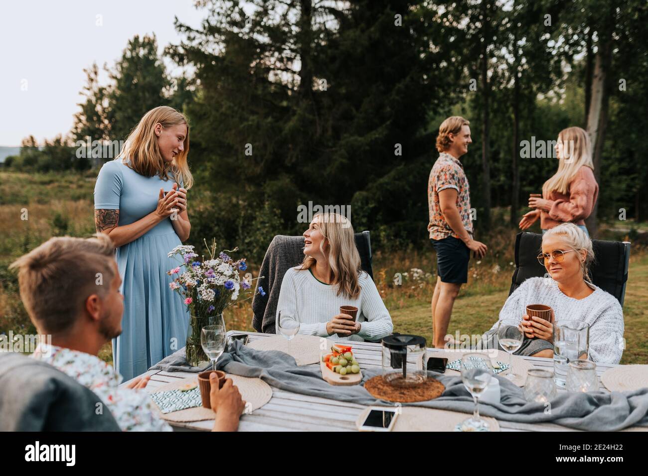 Friends talking in garden Stock Photo
