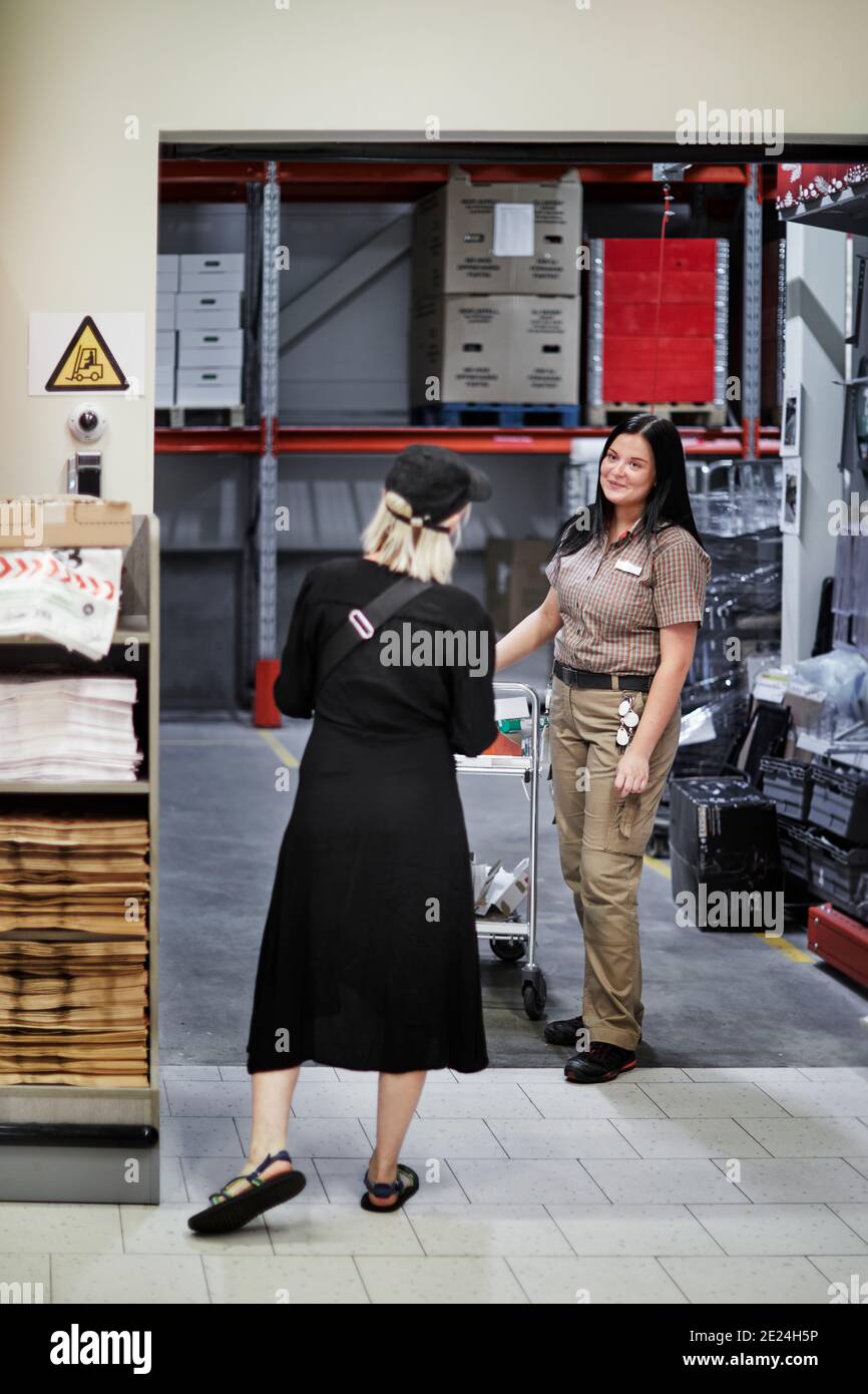 Women in warehouse talking Stock Photo Alamy