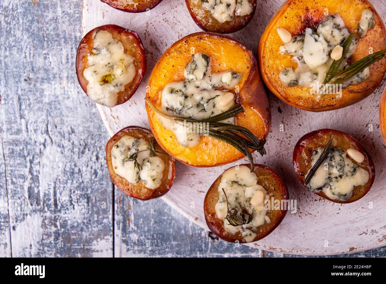 Grilled baked peach and plums stuffed with blue cheese dorblu and