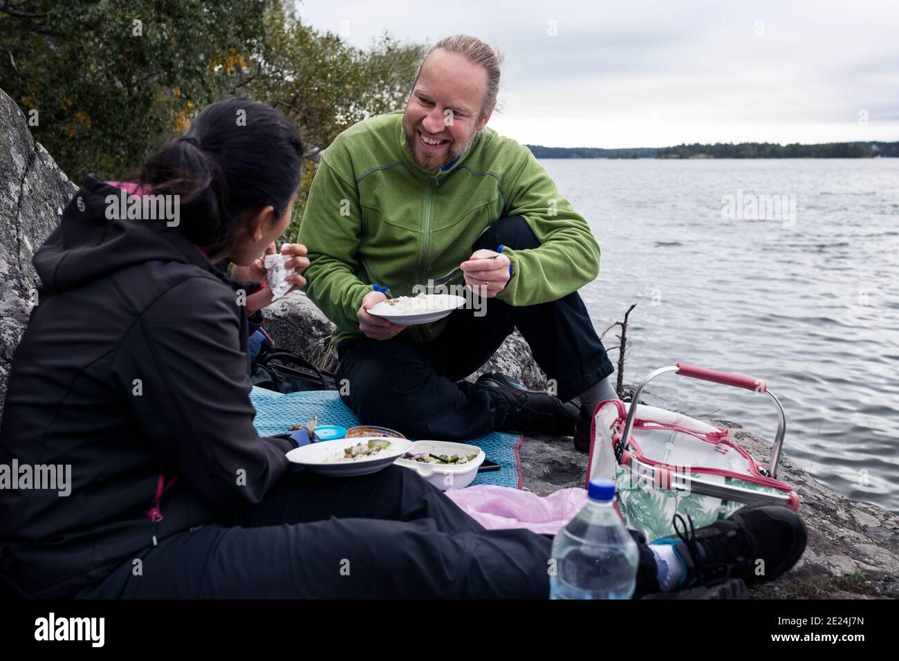 Couple having picnic at lake Stock Photo