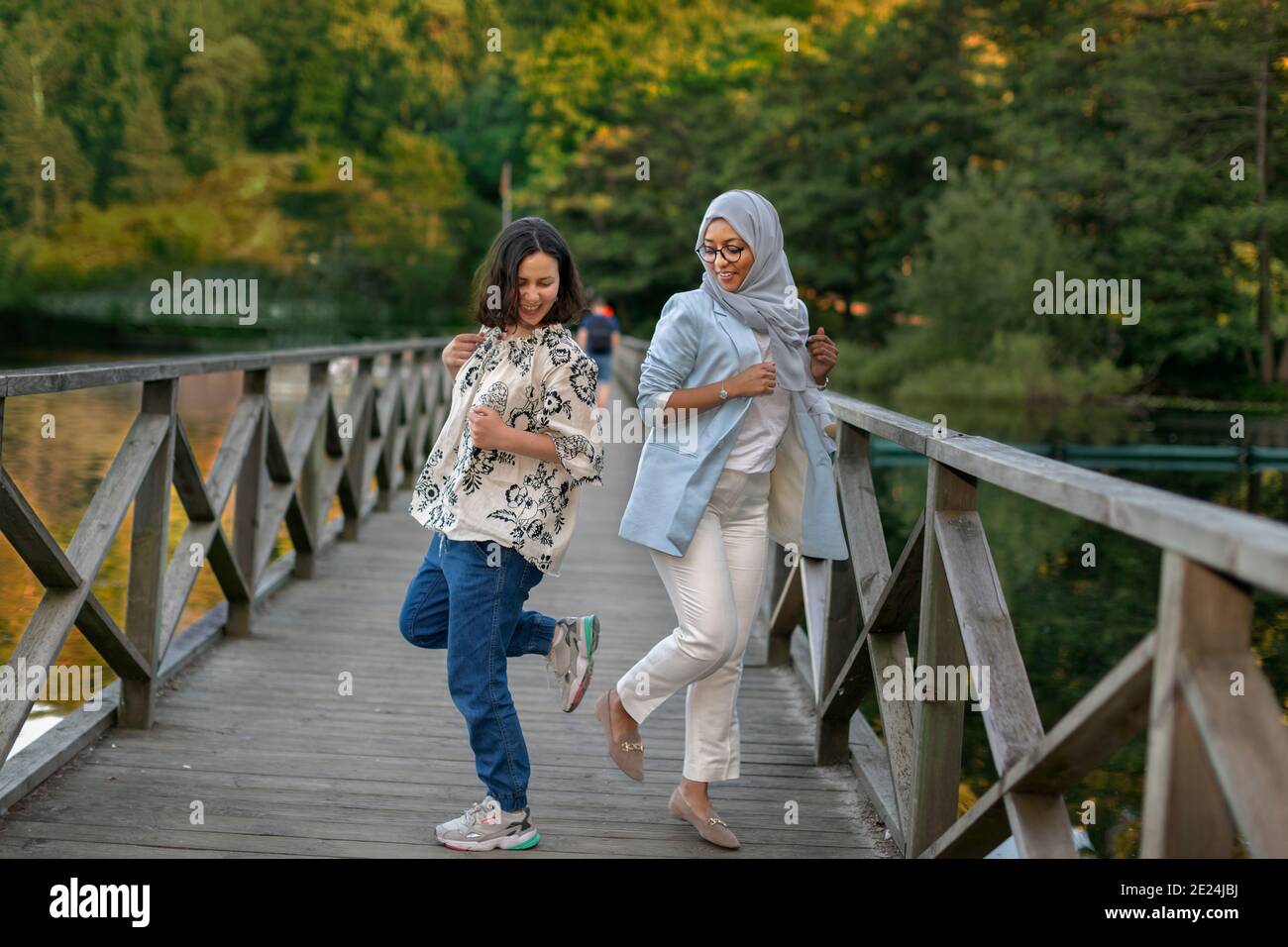Female friends doing footshake Stock Photo