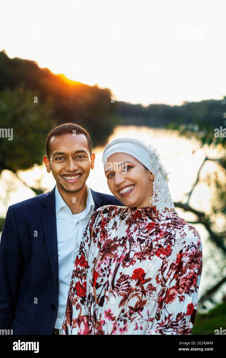 Couple standing at lake Stock Photo