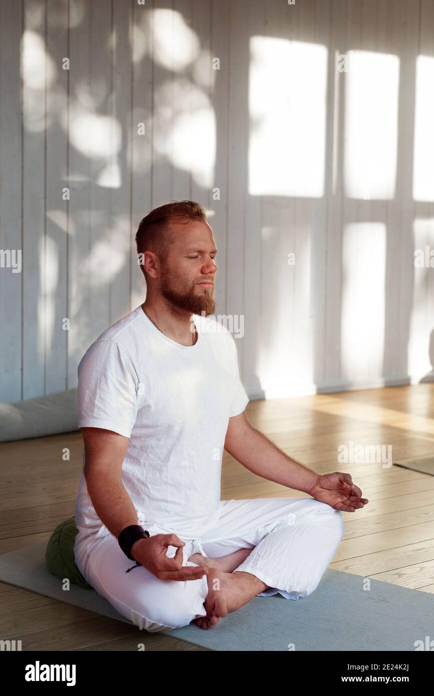 Man practicing yoga in studio Stock Photo