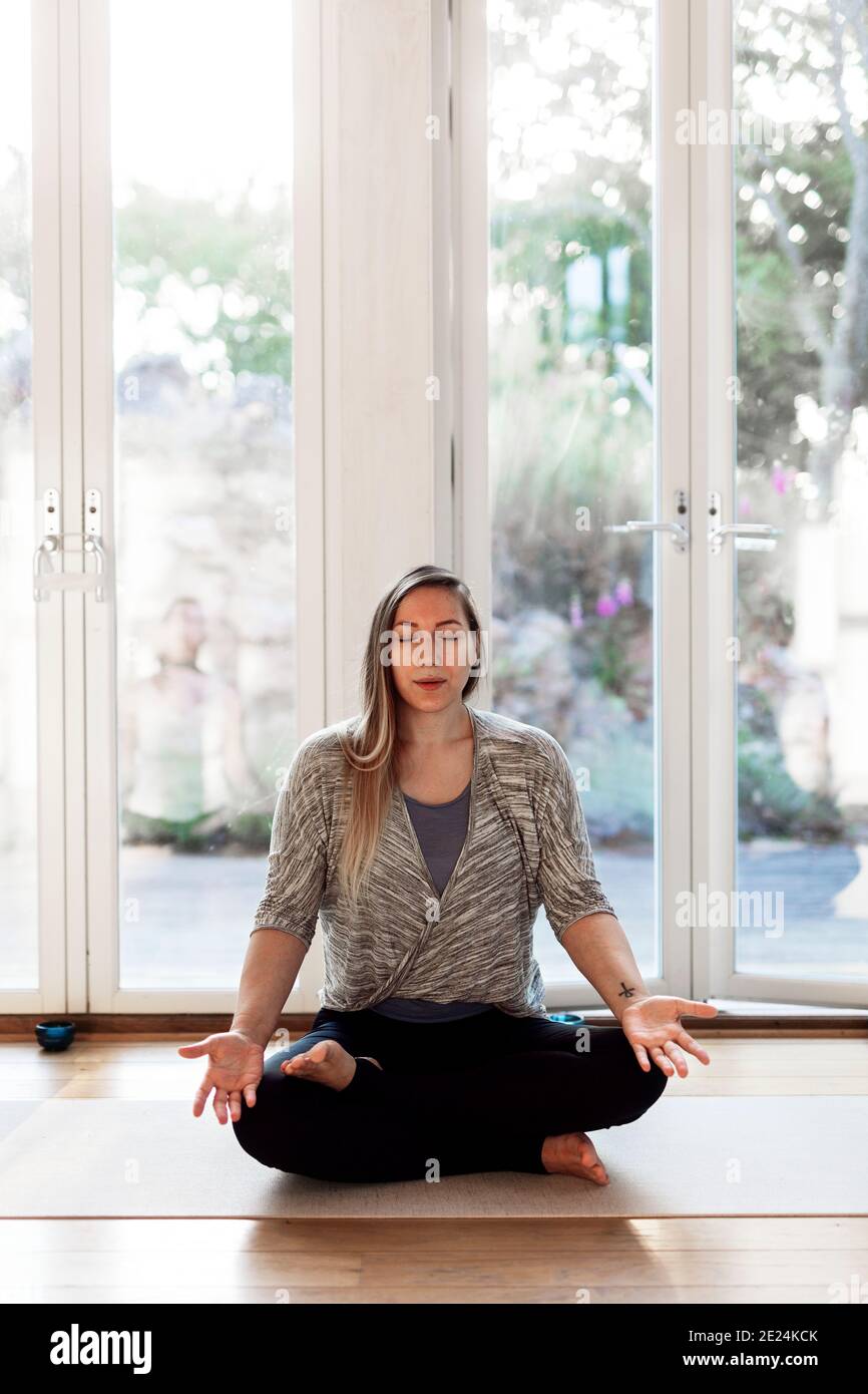 Woman practicing yoga in studio Stock Photo