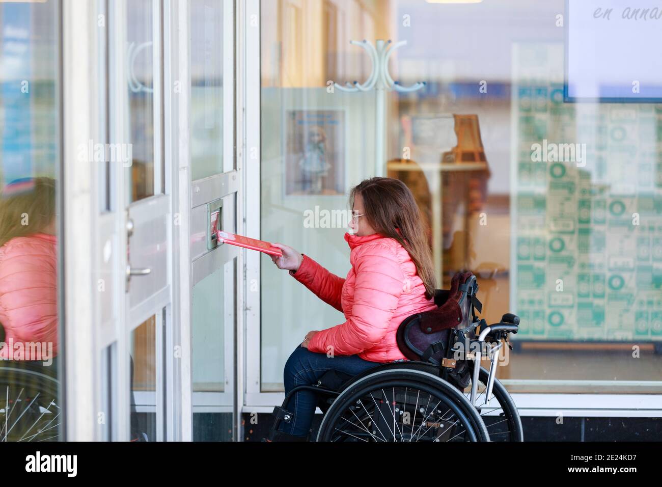 Woman on wheelchair opening door Stock Photo Alamy