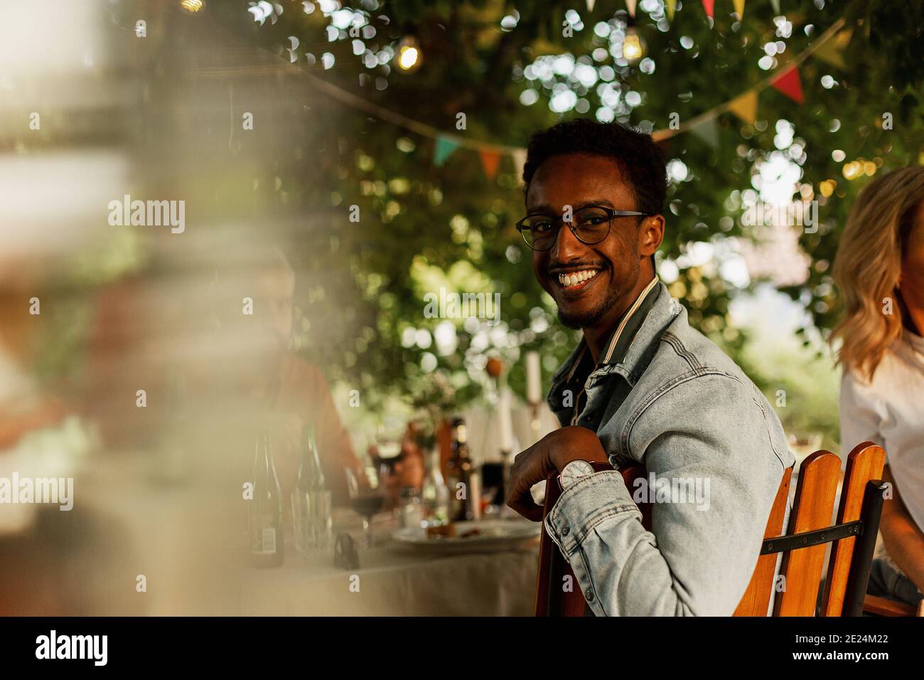 Man sitting at table in garden Stock Photo