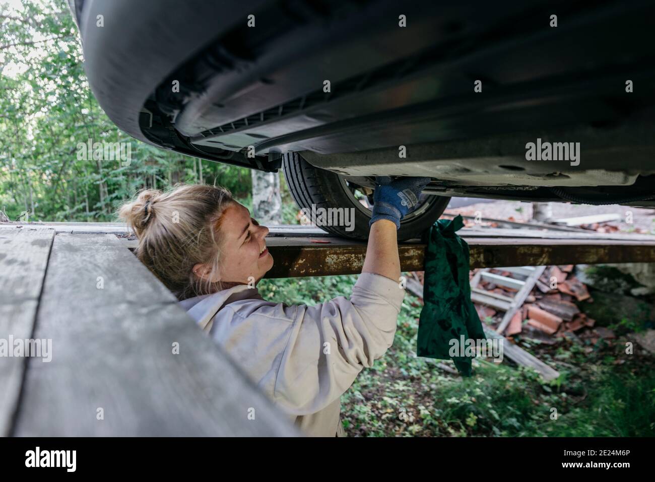 Woman repairing car Stock Photo