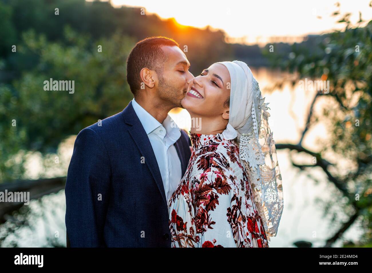 Couple standing at lake Stock Photo
