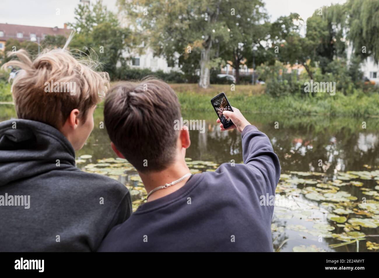 Rear view of two teenage boys taking selfie Stock Photo - Alamy