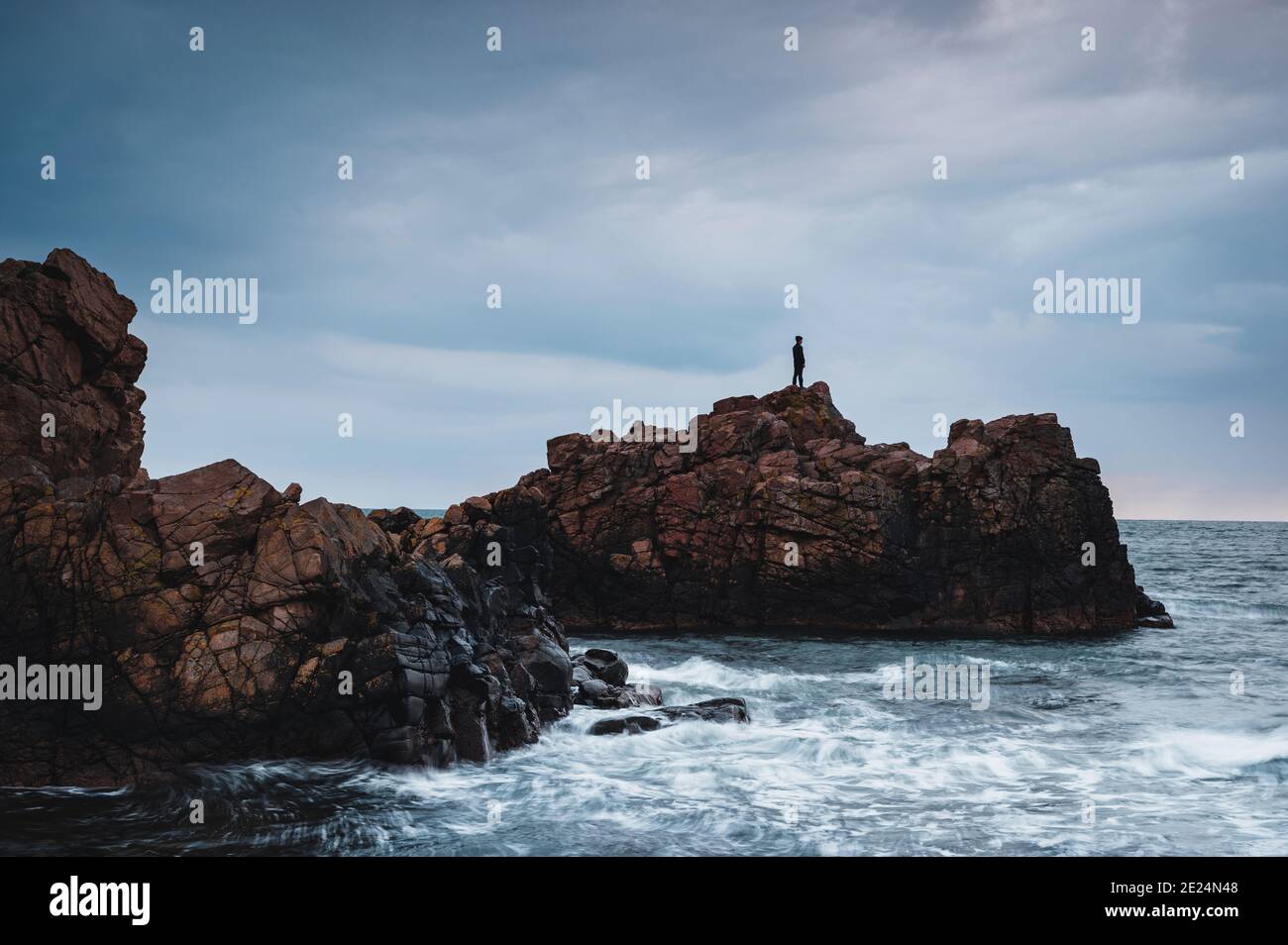 View of rocky coast at sunset Stock Photo