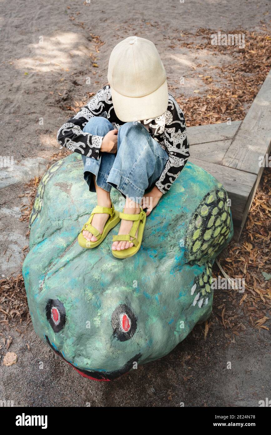 Girl sitting on rock hi-res stock photography and images - Alamy