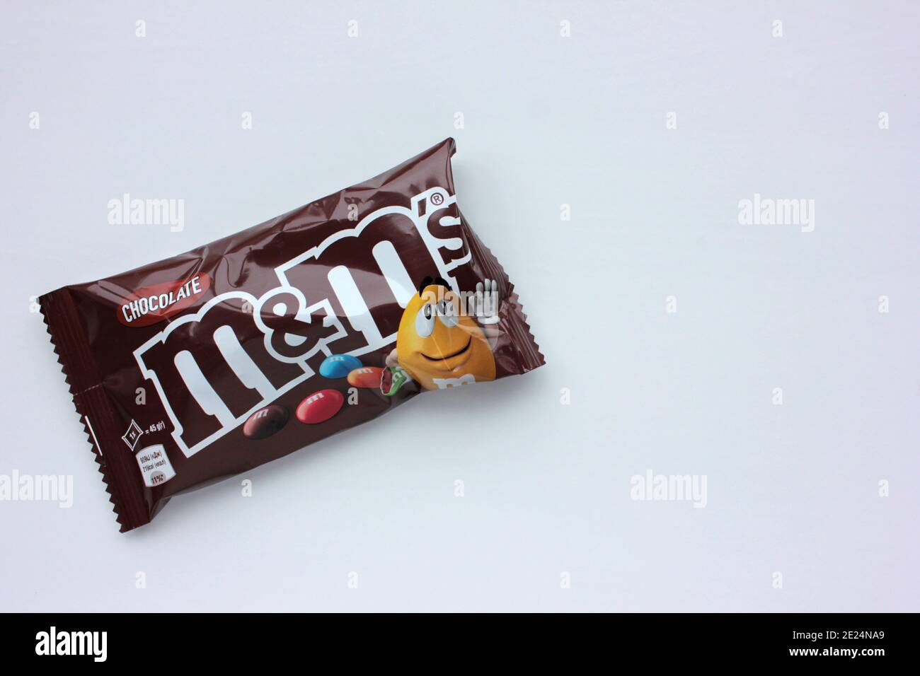 Closeup of M&M's milk chocolate candies made by Mars Inc. on white ...