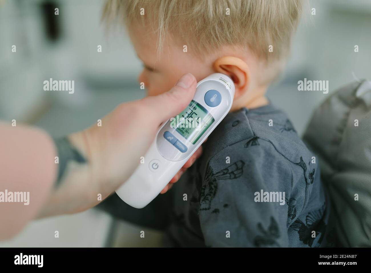 Mother checking toddler temperature Stock Photo Alamy